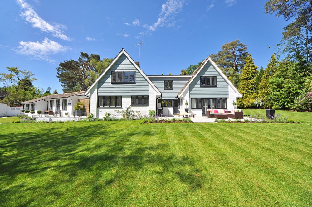 A maintained green residential lawn and landscape